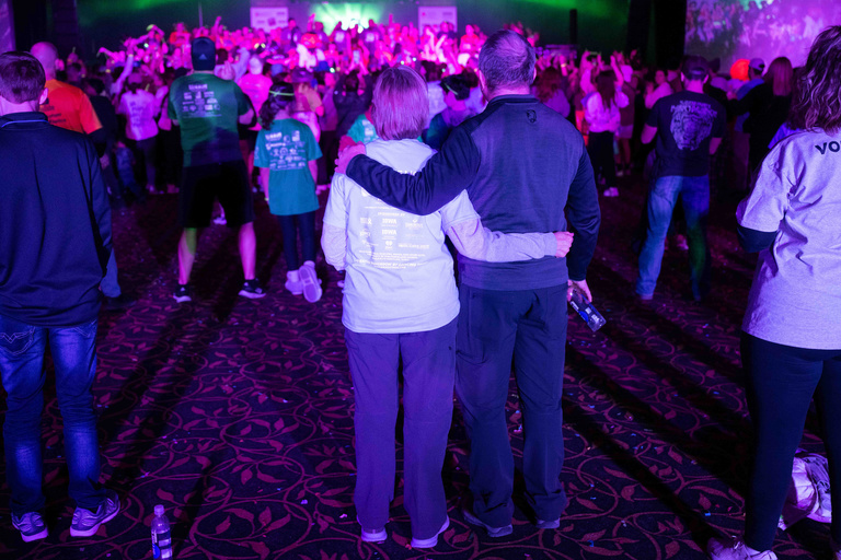 family holds each other at dance marathon